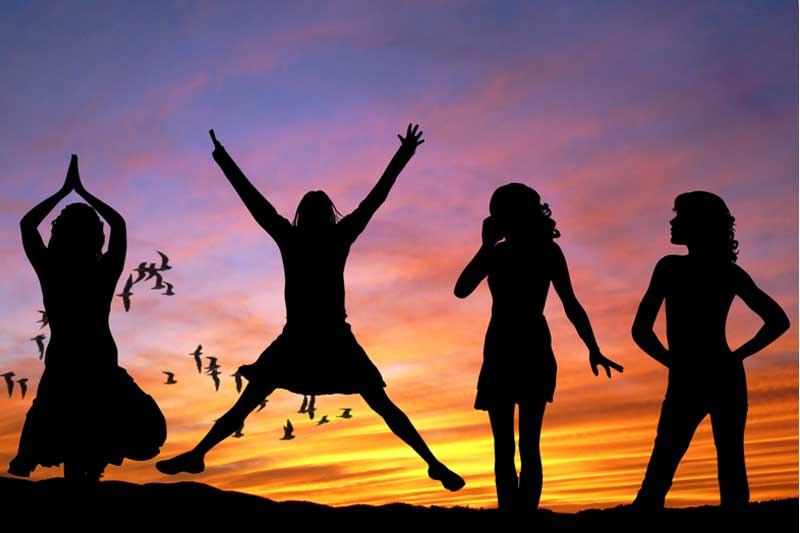 Photo of girls playing at sunset.
