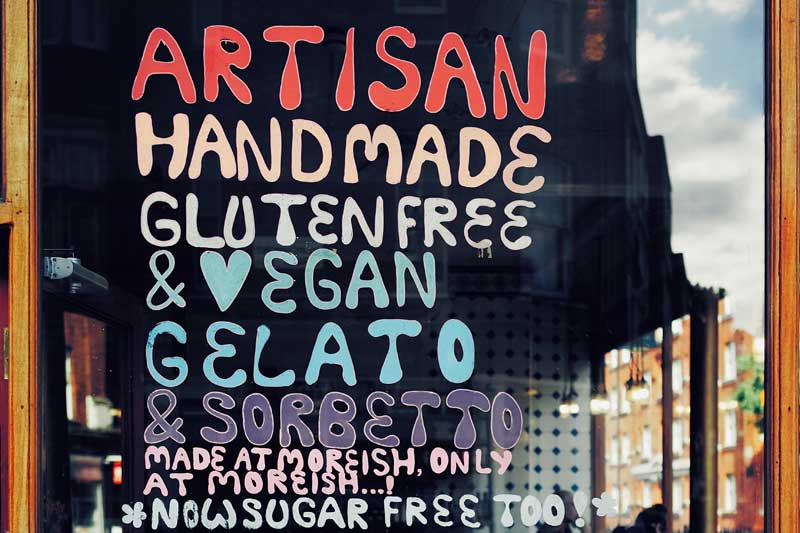 Photo of Gluten-Free and Vegan lettering in shop window.