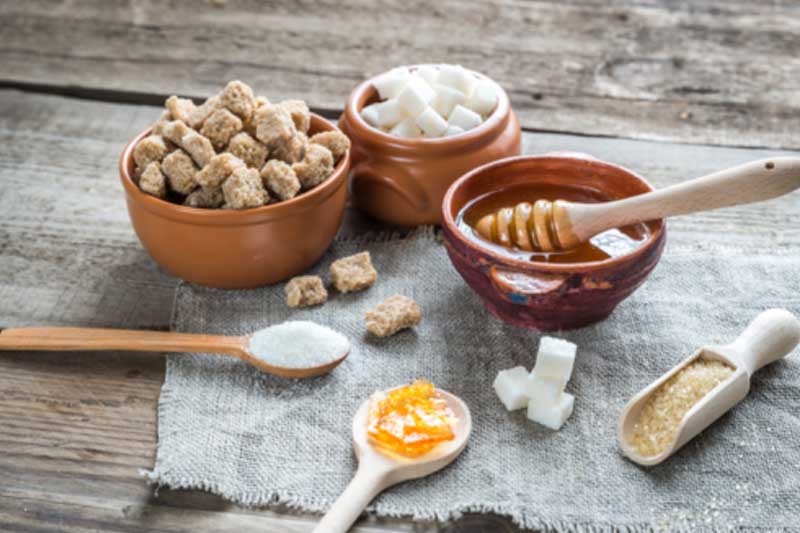Photo of four different sources of sugar.