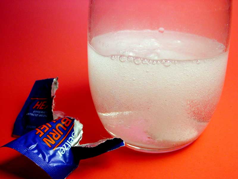 Photo of a heartburn tonic in a glass of water.