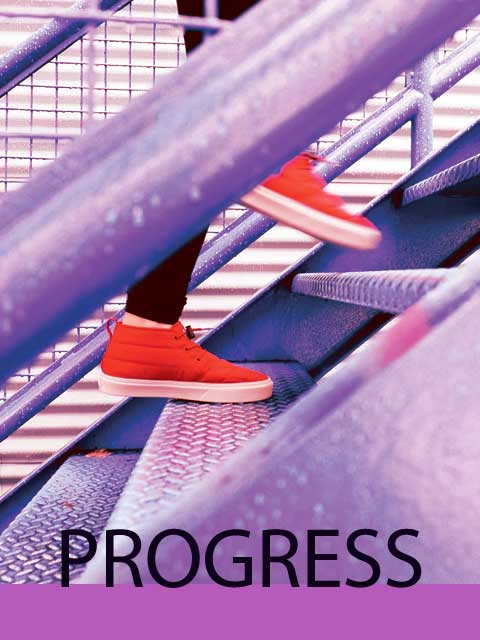 Photo of someone walking up stairs wearing orange sneakers.